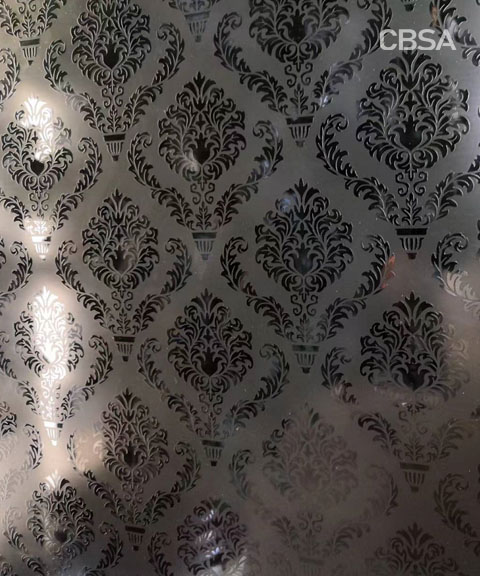 The stainless steel surface is engraved with patterns.